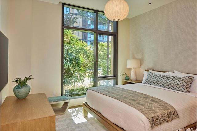 bedroom featuring multiple windows and floor to ceiling windows