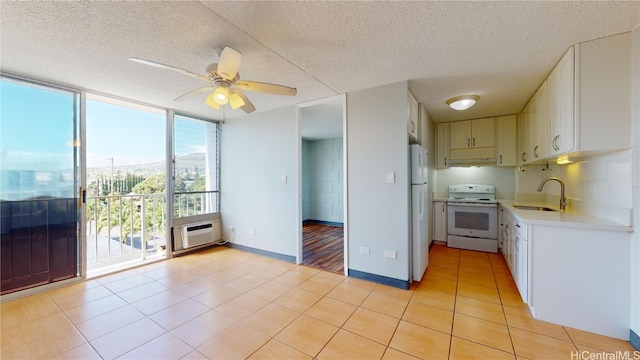 kitchen featuring sink, white cabinetry, a textured ceiling, white appliances, and ceiling fan