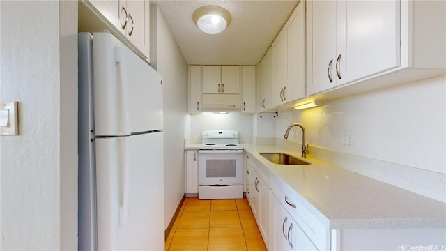 kitchen featuring sink, light tile patterned flooring, white cabinets, a textured ceiling, and white appliances