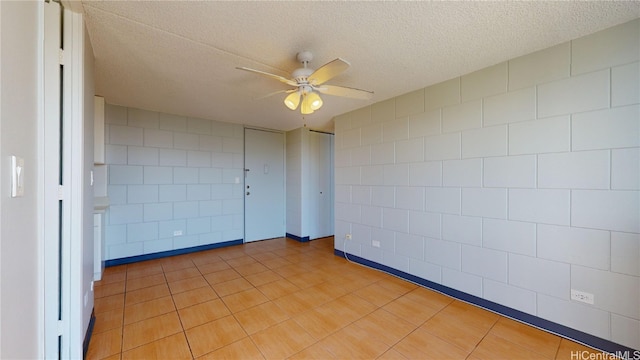 empty room featuring a textured ceiling and ceiling fan