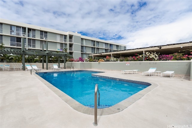 view of pool with a patio and a pergola