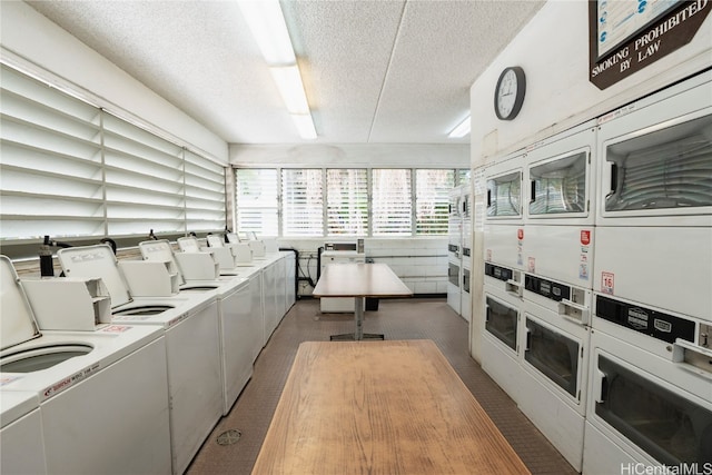 washroom with a textured ceiling, stacked washer and dryer, washing machine and dryer, and dark carpet