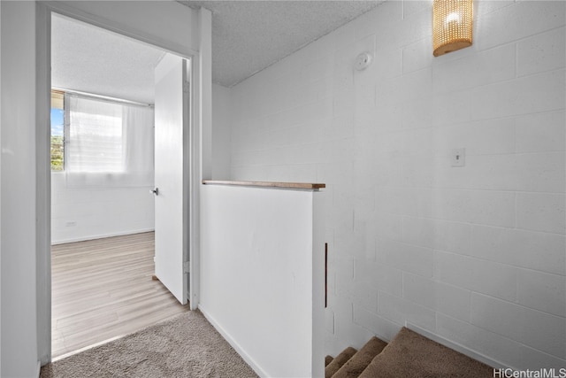 bathroom featuring a textured ceiling and wood-type flooring