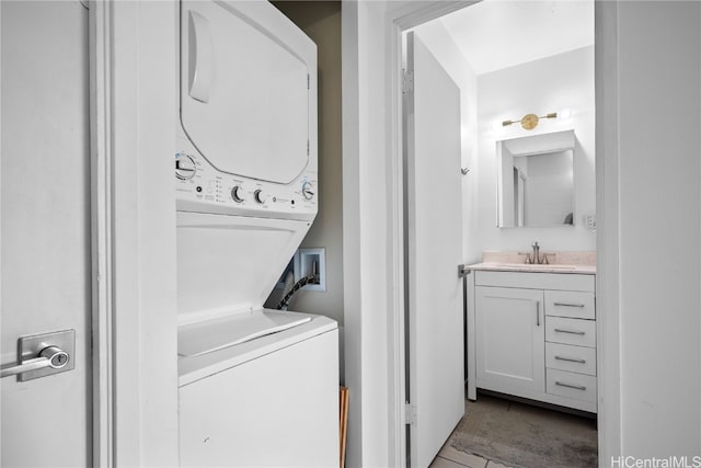 laundry room with stacked washing maching and dryer and sink