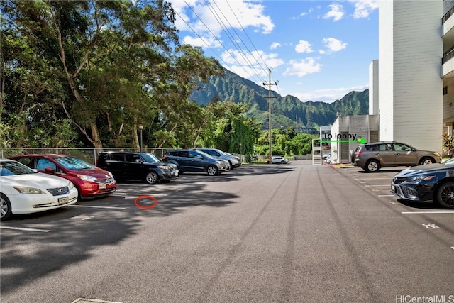 view of car parking featuring a mountain view