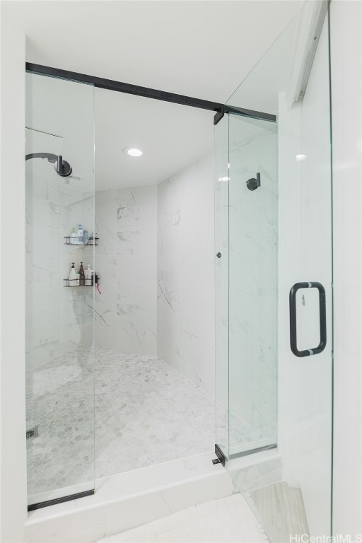 bathroom featuring a shower with shower door