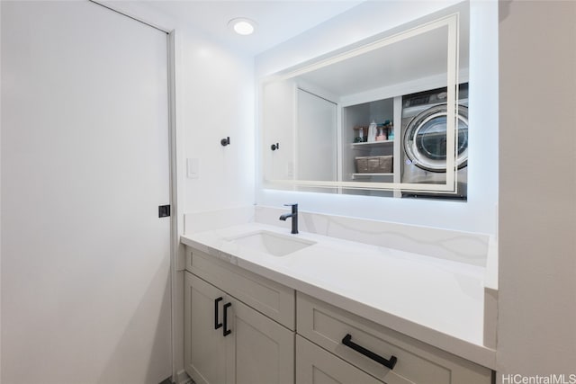 bathroom with washer / dryer and vanity