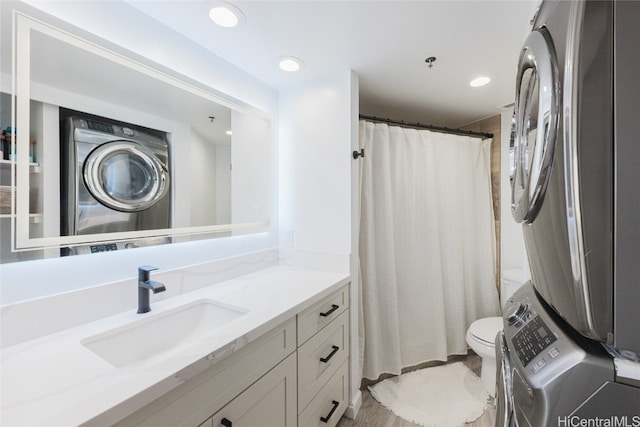 bathroom with toilet, stacked washing maching and dryer, vanity, and a shower with shower curtain