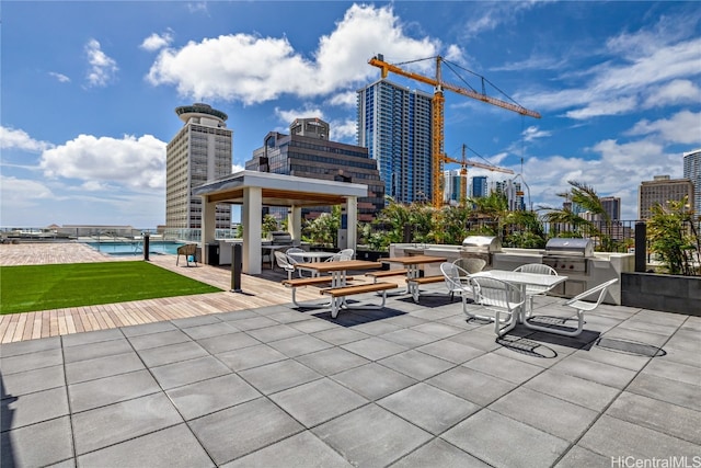 view of patio with exterior kitchen, a gazebo, and a grill