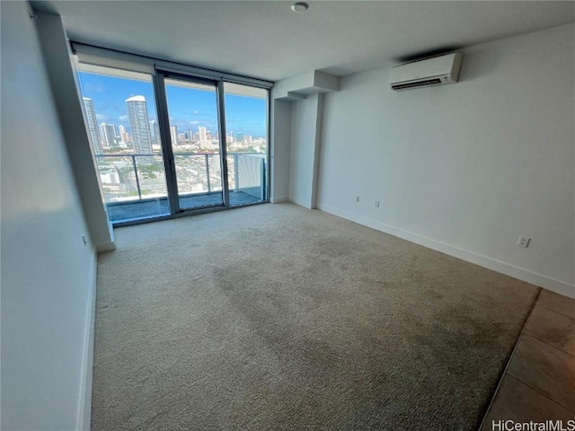 empty room with expansive windows, an AC wall unit, and carpet