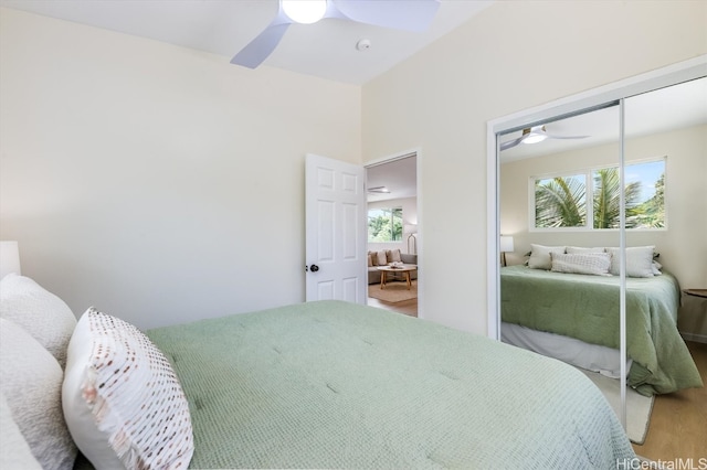 bedroom featuring a closet, hardwood / wood-style floors, and ceiling fan