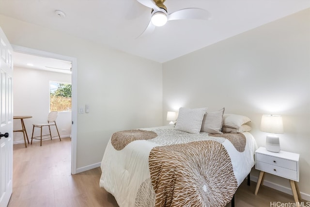 bedroom with ceiling fan and wood-type flooring