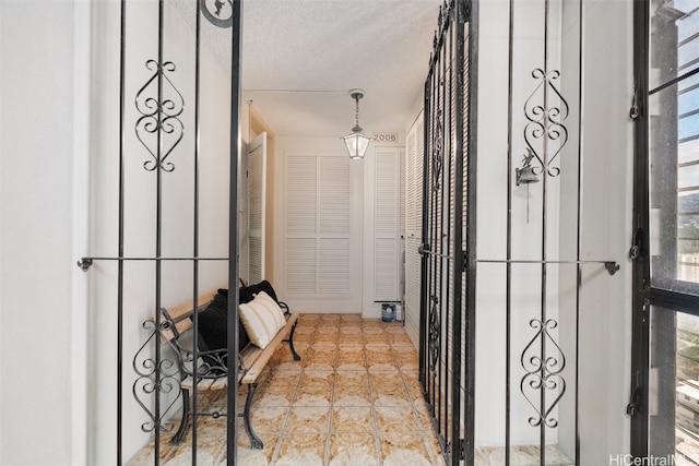 corridor with a textured ceiling