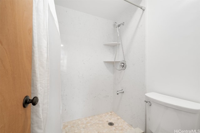 bathroom with toilet and walk in shower