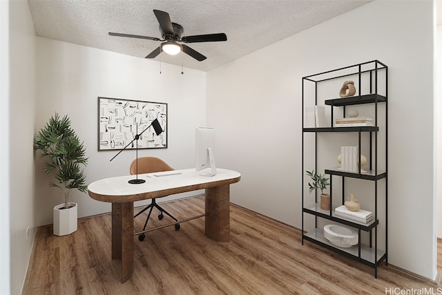 office featuring hardwood / wood-style floors, a textured ceiling, and ceiling fan