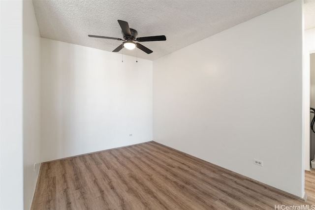 spare room with ceiling fan, a textured ceiling, and light hardwood / wood-style flooring