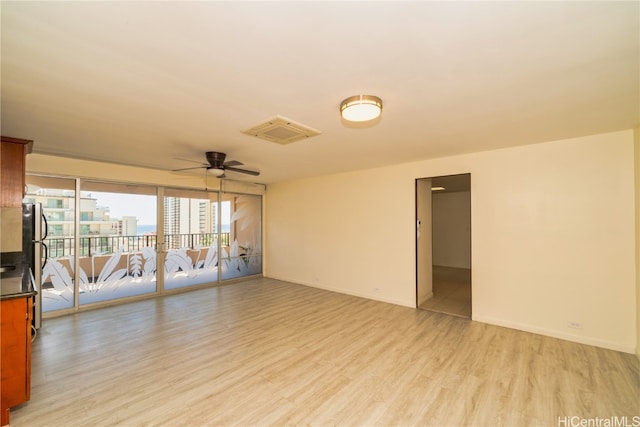 unfurnished room featuring light hardwood / wood-style floors and ceiling fan