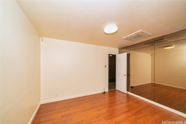 unfurnished bedroom with a closet and wood-type flooring