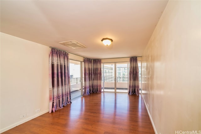 unfurnished room featuring dark wood-type flooring