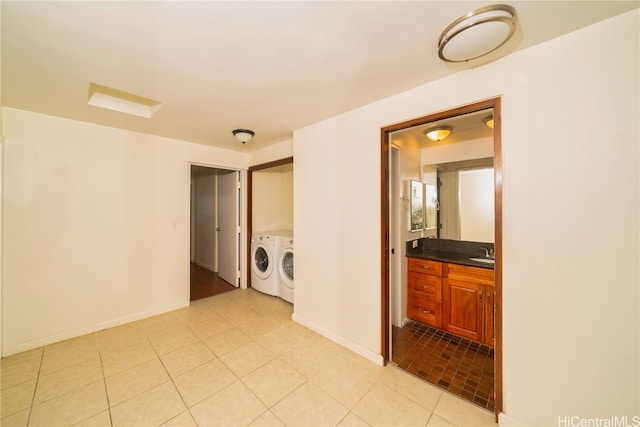 laundry room with independent washer and dryer, sink, and light tile patterned floors