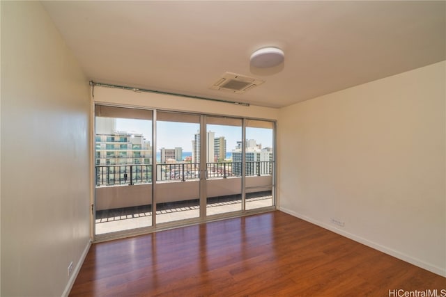 empty room with hardwood / wood-style floors