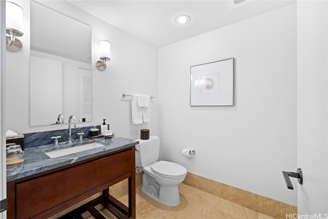 bathroom featuring tile patterned flooring, vanity, and toilet