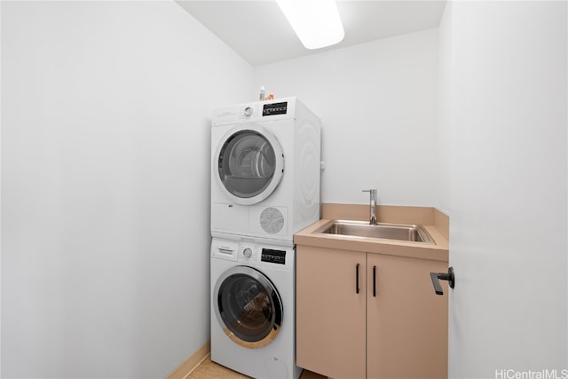 clothes washing area featuring sink and stacked washer / drying machine