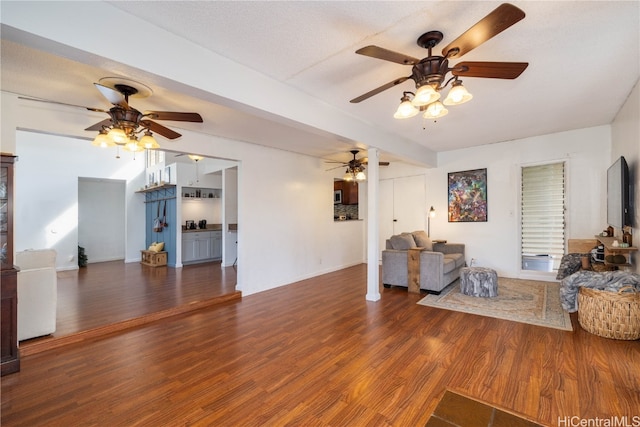 living room featuring a textured ceiling, ceiling fan, and dark hardwood / wood-style flooring