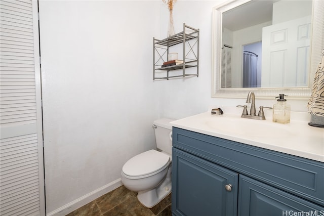 bathroom with vanity, toilet, and tile patterned floors