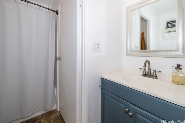 bathroom featuring vanity, walk in shower, and tile patterned flooring