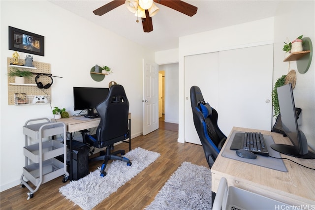 home office with dark hardwood / wood-style floors and ceiling fan