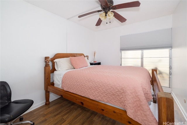 bedroom with dark hardwood / wood-style floors and ceiling fan