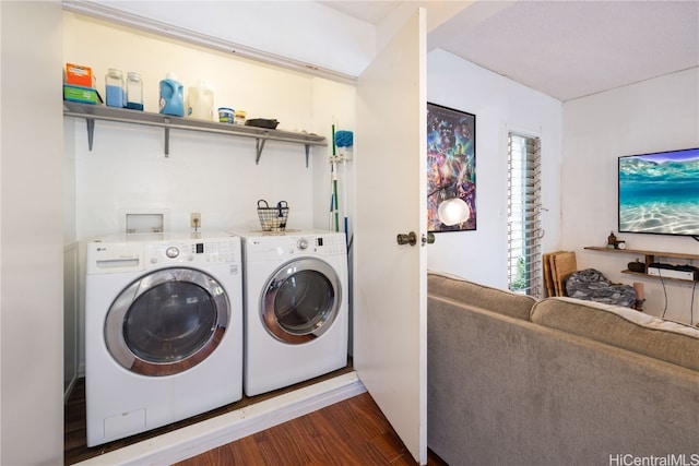 laundry area with dark wood-type flooring and independent washer and dryer