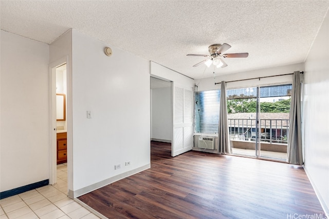 spare room featuring hardwood / wood-style floors, a textured ceiling, and ceiling fan