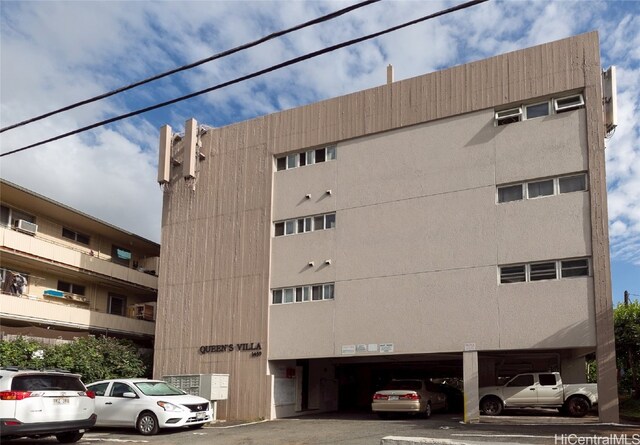 view of property featuring uncovered parking