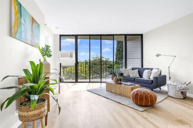 living room with a wall of windows and hardwood / wood-style floors