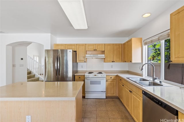 kitchen featuring a center island, sink, stainless steel appliances, and extractor fan