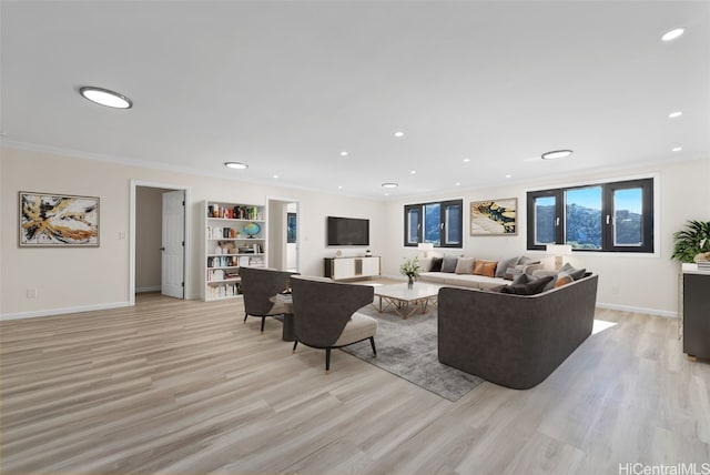 living room with light hardwood / wood-style floors and ornamental molding