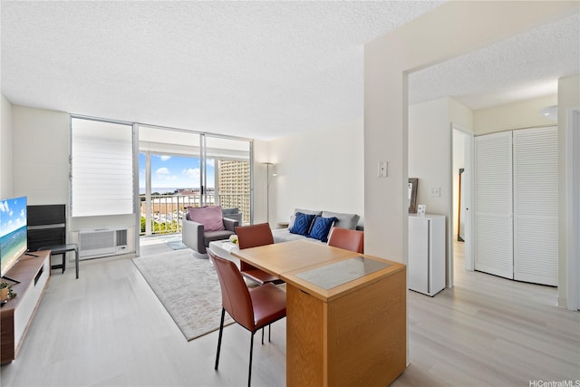 475 Atkinson Dr Unit 1702, Honolulu, HI 96814 - dining space featuring light wood-style flooring, a textured ceiling, floor to ceiling windows, washer and clothes dryer, and cooling unit