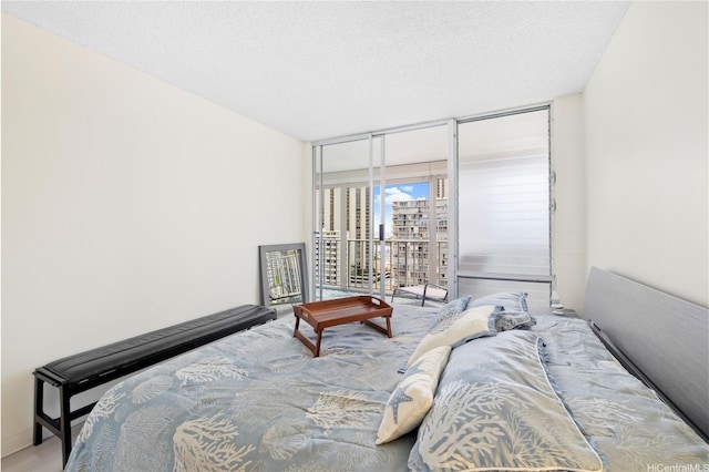 475 Atkinson Dr Unit 1702, Honolulu, HI 96814 - bedroom featuring access to exterior, a textured ceiling, and a wall of windows