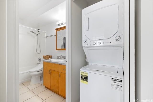 washroom with stacked washer / dryer, sink, and light tile patterned floors