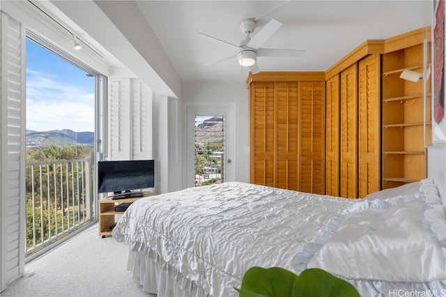 bedroom with access to exterior, multiple windows, carpet floors, and ceiling fan