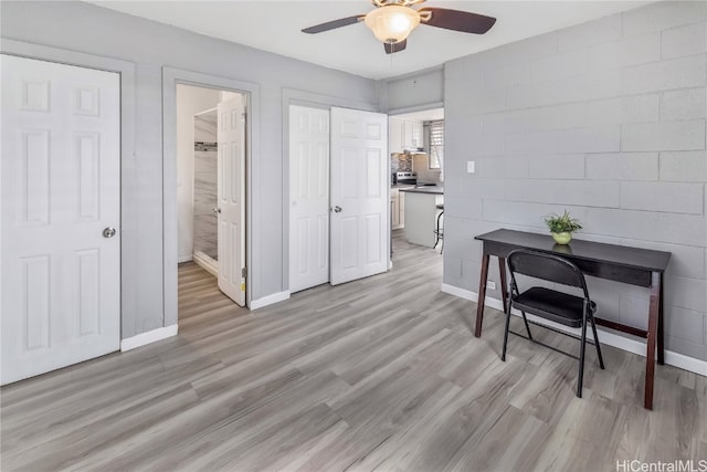 interior space with ceiling fan and light hardwood / wood-style floors