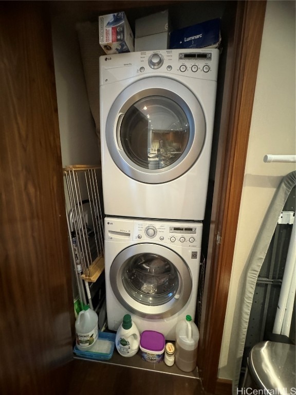 washroom featuring stacked washer / drying machine