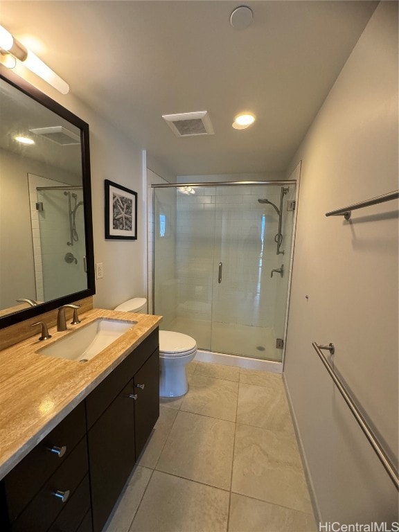 bathroom with toilet, tile patterned flooring, vanity, and a shower with door