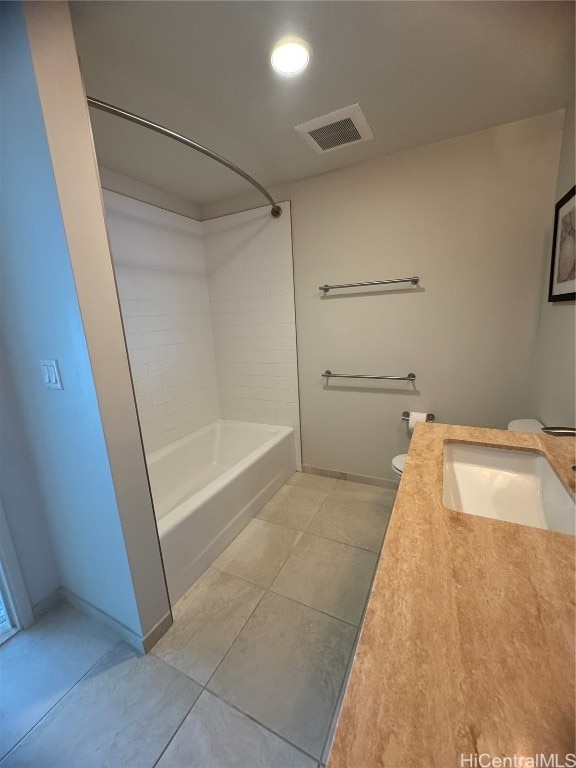 full bathroom featuring toilet, tiled shower / bath combo, vanity, and tile patterned floors