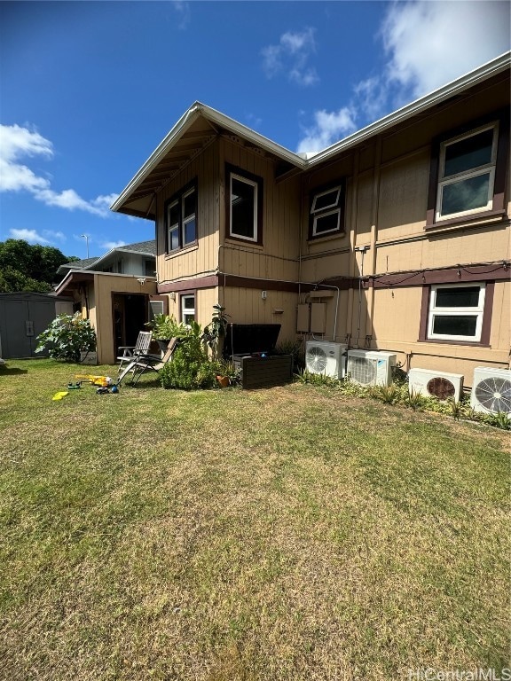 rear view of house with a lawn