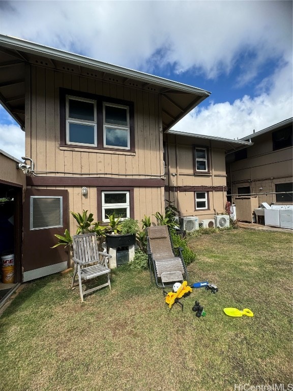 back of house featuring a yard and central AC unit