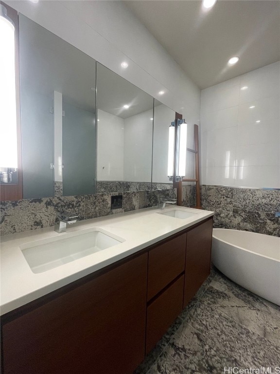 bathroom with vanity and a bathtub