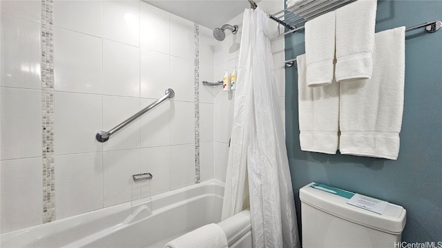 bathroom with shower / tub combo with curtain and toilet